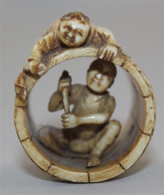 A Japanese ivory netsuke of two men constructing a barrel, Meiji period, 2.8cm